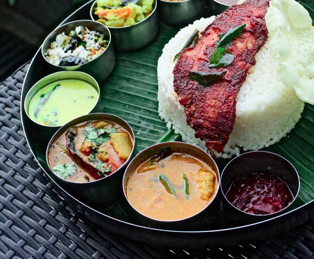 A South Indian rice meal with fried fish and curries